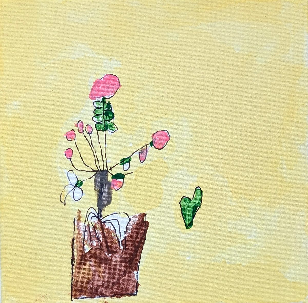 A child's painting of flowers in a pot, hanging in the office